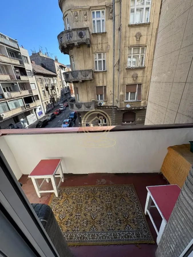 Balcony with a view of the street and surrounding buildings.