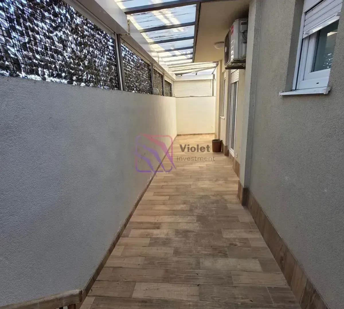 Covered balcony with tiled floor and walls.