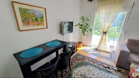 Living room with a dining table and access to the terrace. - image 7