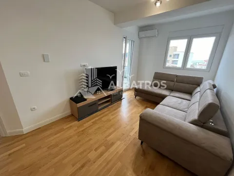 Living room with a corner sofa, TV unit, and access to the terrace. - image 5