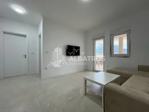Living room with a sofa and wall-mounted television. - image 5