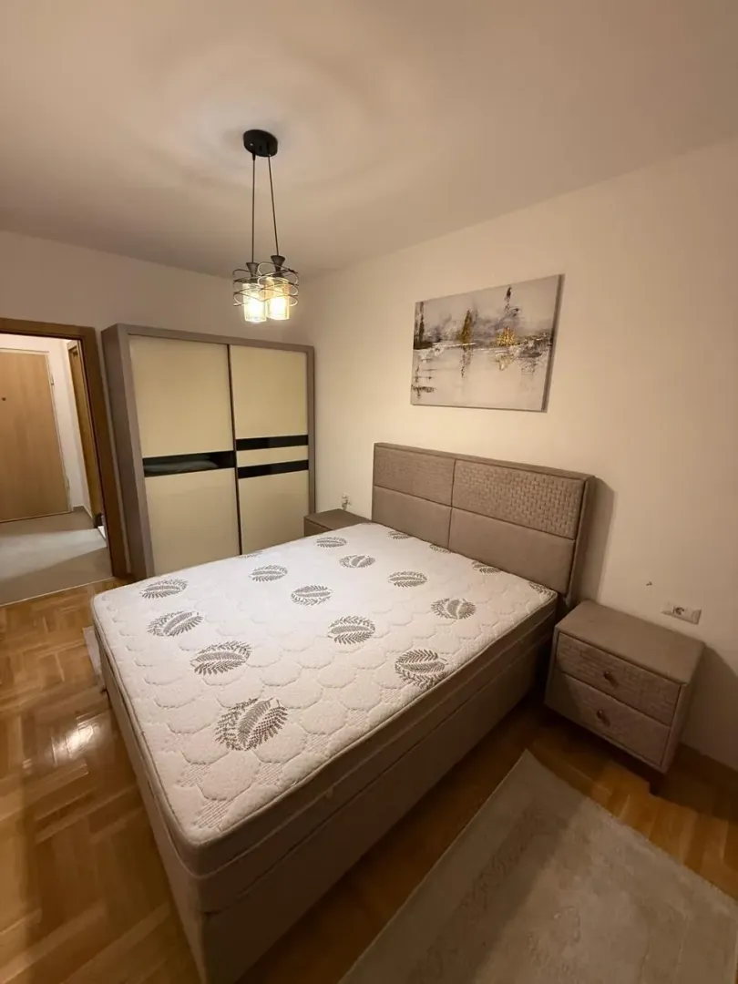 Furnished bedroom with a double bed, wardrobe, and nightstands.