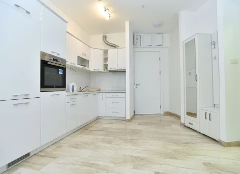Modern white kitchen with built-in appliances. - image 8