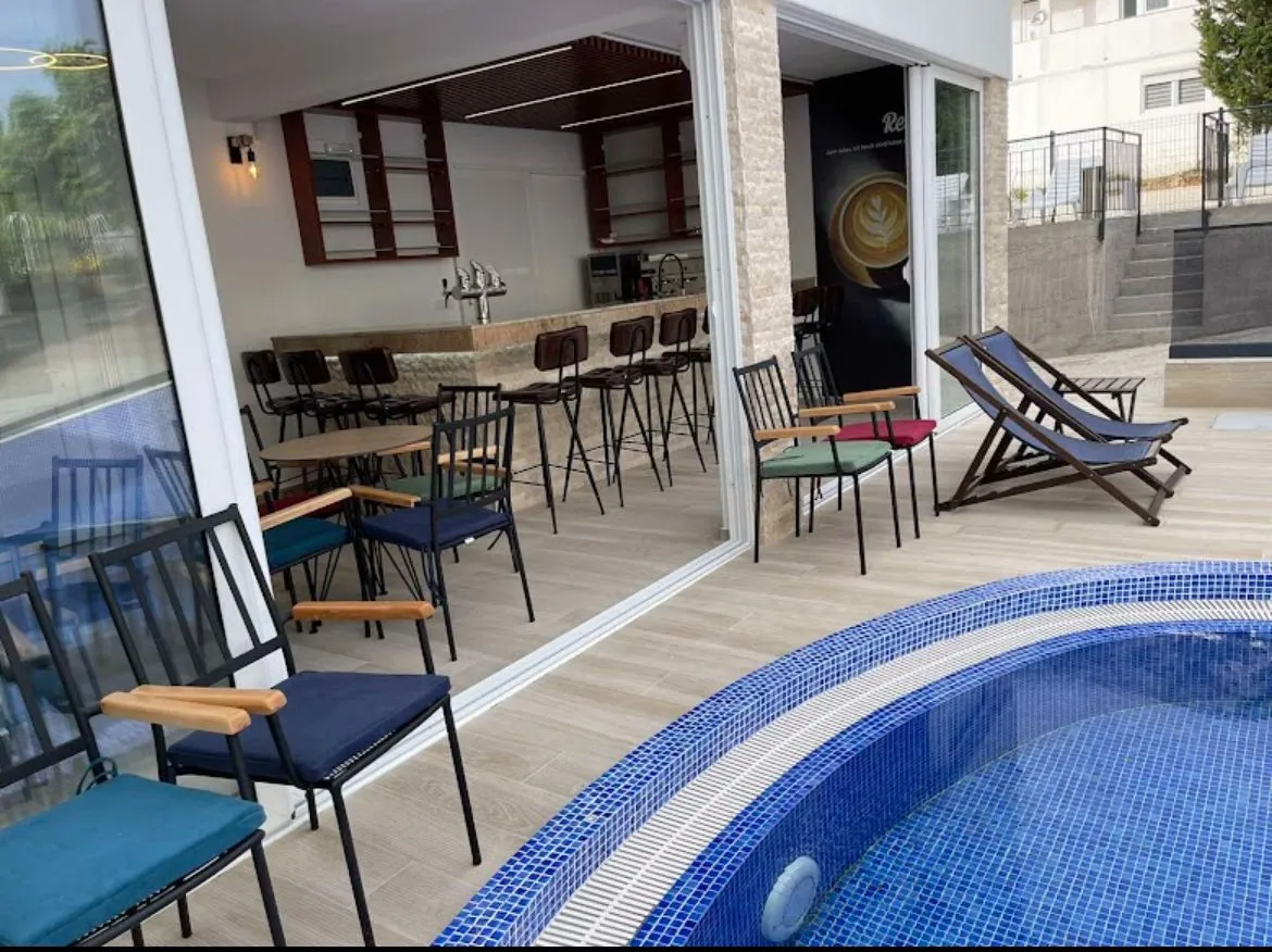 Terrace with a swimming pool and a bar within the property.