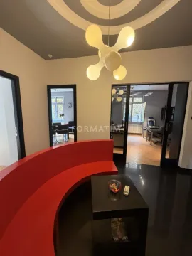 Living room with a red curved sofa and a modern chandelier. - image 11