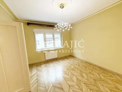 Empty room with parquet flooring and white walls. - image 2