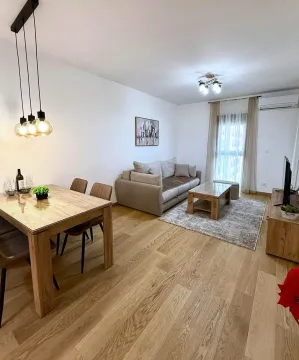 Spacious living room with a dining area and wooden flooring. - image 4