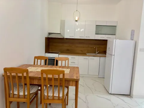 Kitchen with dining area and wooden table. - image 2