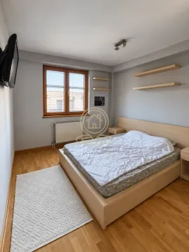Bedroom with a double bed, wooden flooring, and a window. - image 10