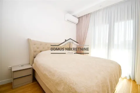 Spacious bedroom with a double bed and a nightstand. - image 9