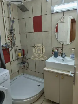 Small bathroom with a shower cabin, washbasin, and mirror. - image 8