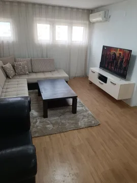 Living room with sofa, coffee table and TV. - image 3