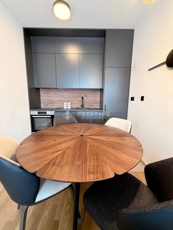 Modern kitchen with a dining table and chairs.