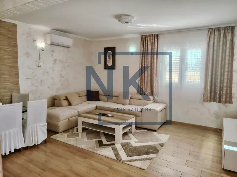 Living room with a sofa set, coffee table, and dining table.