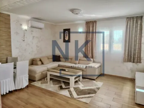 Living room with a sofa set, coffee table, and dining table. - image 2