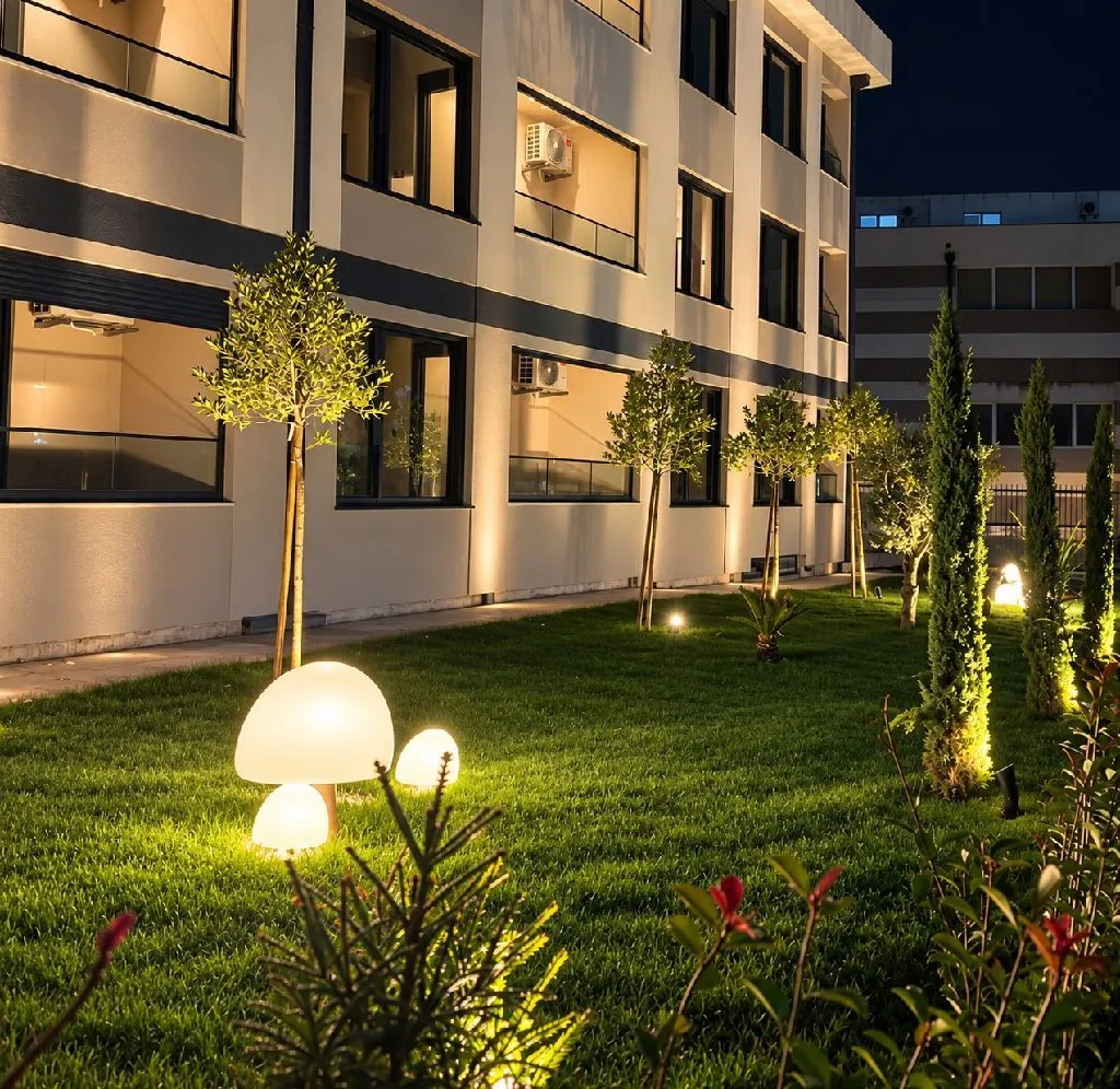 Illuminated courtyard and facade of an apartment building at night.