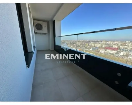 Spacious balcony with a glass railing and a city view. - image 21