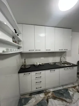 Bright kitchen with white cabinets and a dark countertop. - image 4