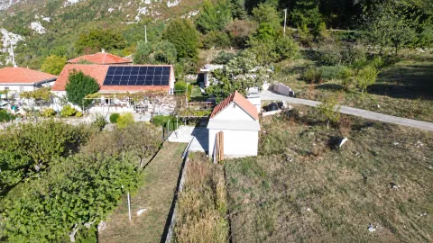 Aerial view of a house with solar panels and yard. - image 11