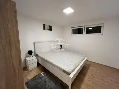 Furnished bedroom with a white bed and a nightstand. - image 4