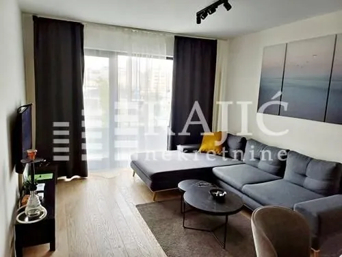 Living room with sofa, coffee table and TV.