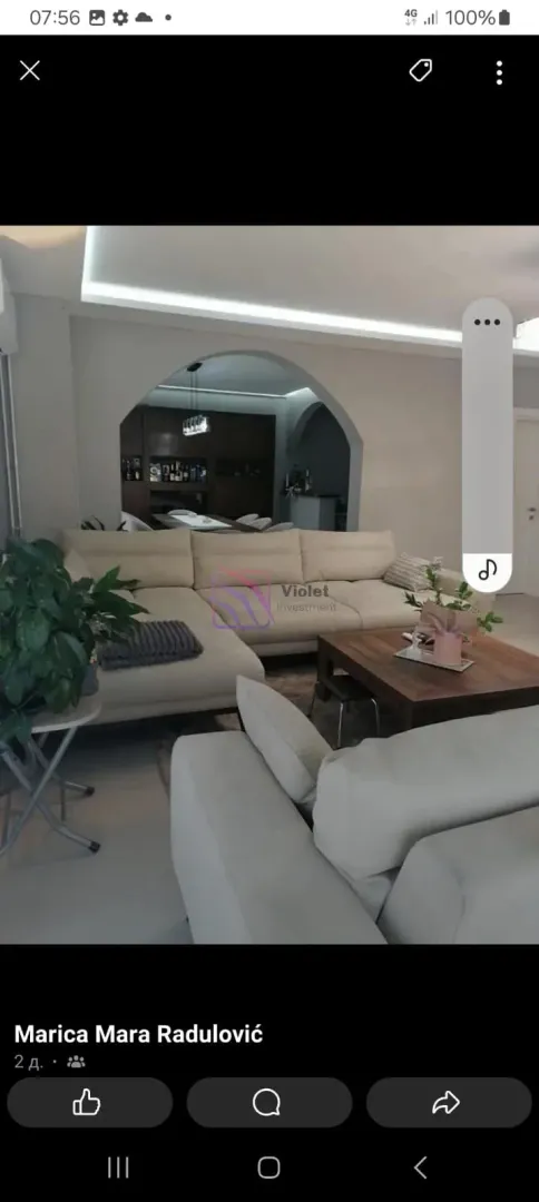 Spacious living room with seating furniture and a view of the dining area.
