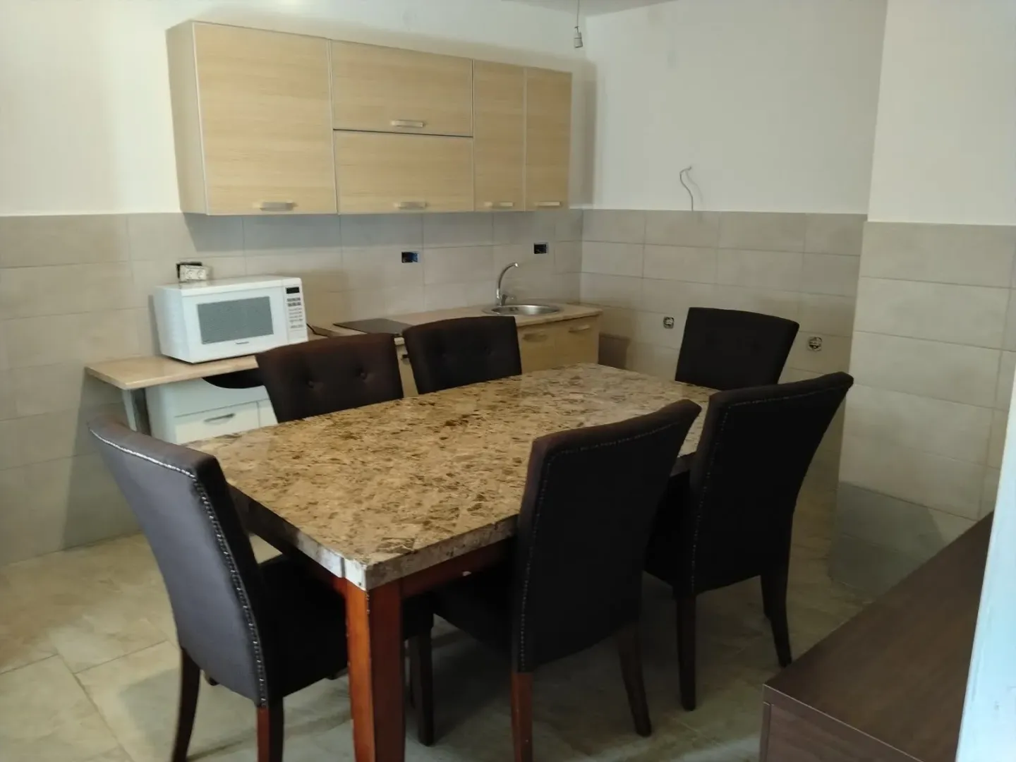 Small kitchen with a dining table and chairs.
