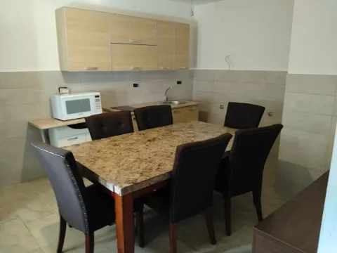 Small kitchen with a dining table and chairs. - image 2