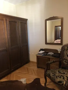 A corner of a bedroom featuring classic wooden furniture, a mirror, and parquet flooring. - image 22