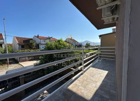 View from the tiled balcony towards surrounding houses and greenery. - image 10