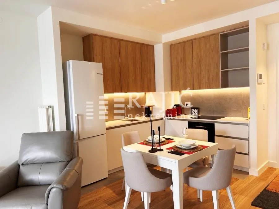Modern kitchen with dining area and built-in appliances.