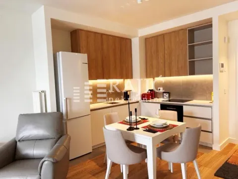 Modern kitchen with dining area and built-in appliances. - image 2