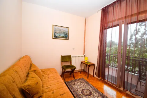Small living room with a sofa, a chair and access to the terrace. - image 11