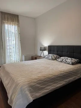 Bright bedroom with a double bed and a nightstand. - image 4