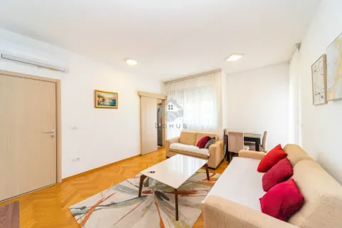 Living room with sofa, coffee table, and a dining area in the background. - image 3