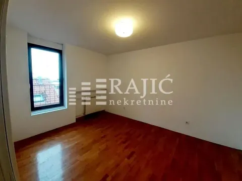 Empty room with parquet flooring and a window. - image 14