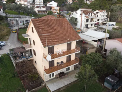 An aerial view of a three-story house with balconies and a yard. - image 2