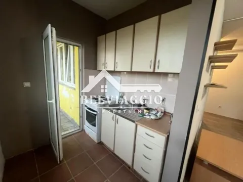 Smaller kitchen with white cabinetry and access to the terrace. - image 12