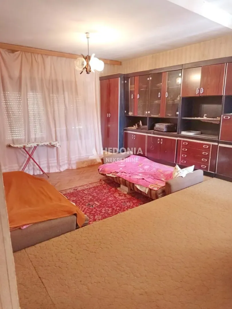 Furnished living room with seating furniture and a large wooden closet.