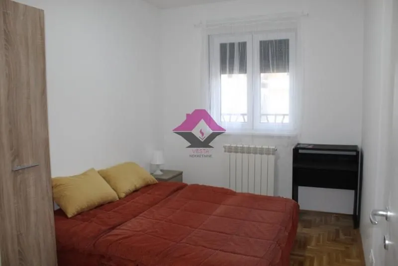 Smaller bedroom with a double bed, wardrobe, and a desk.