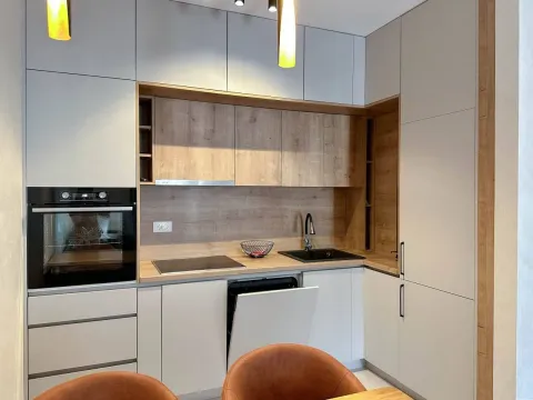 Modern kitchen with built-in appliances and wooden details. - image 3