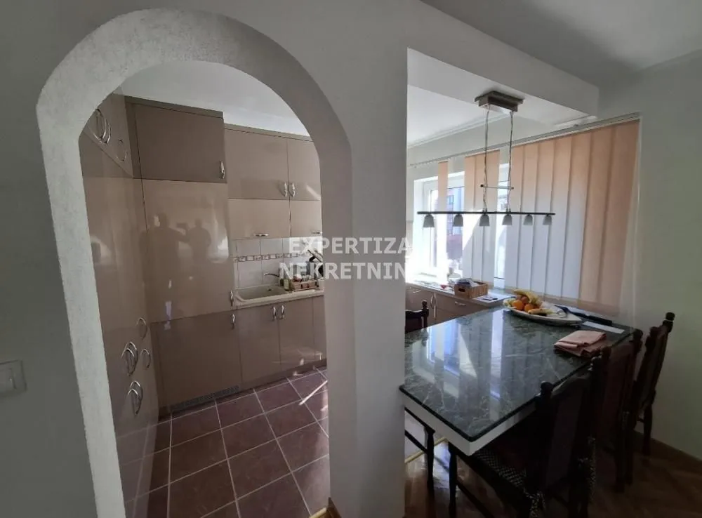 Kitchen with dining area and built-in cabinets.
