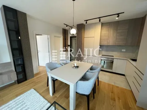 Modern kitchen with dining area and built-in appliances. - image 3