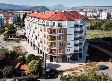 Aerial view of an apartment building with balconies and surrounding area. - image 2