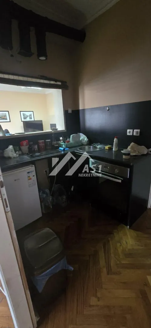 Small kitchen with a sink, oven, and countertops.