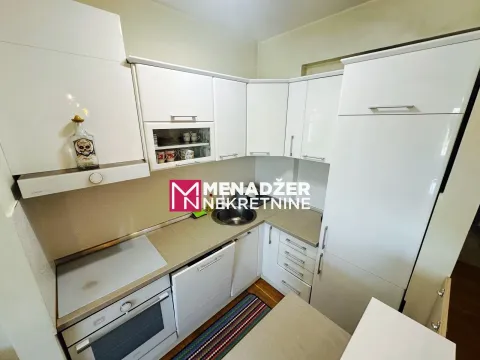 Modern white kitchen with built-in appliances and a sink. - image 5