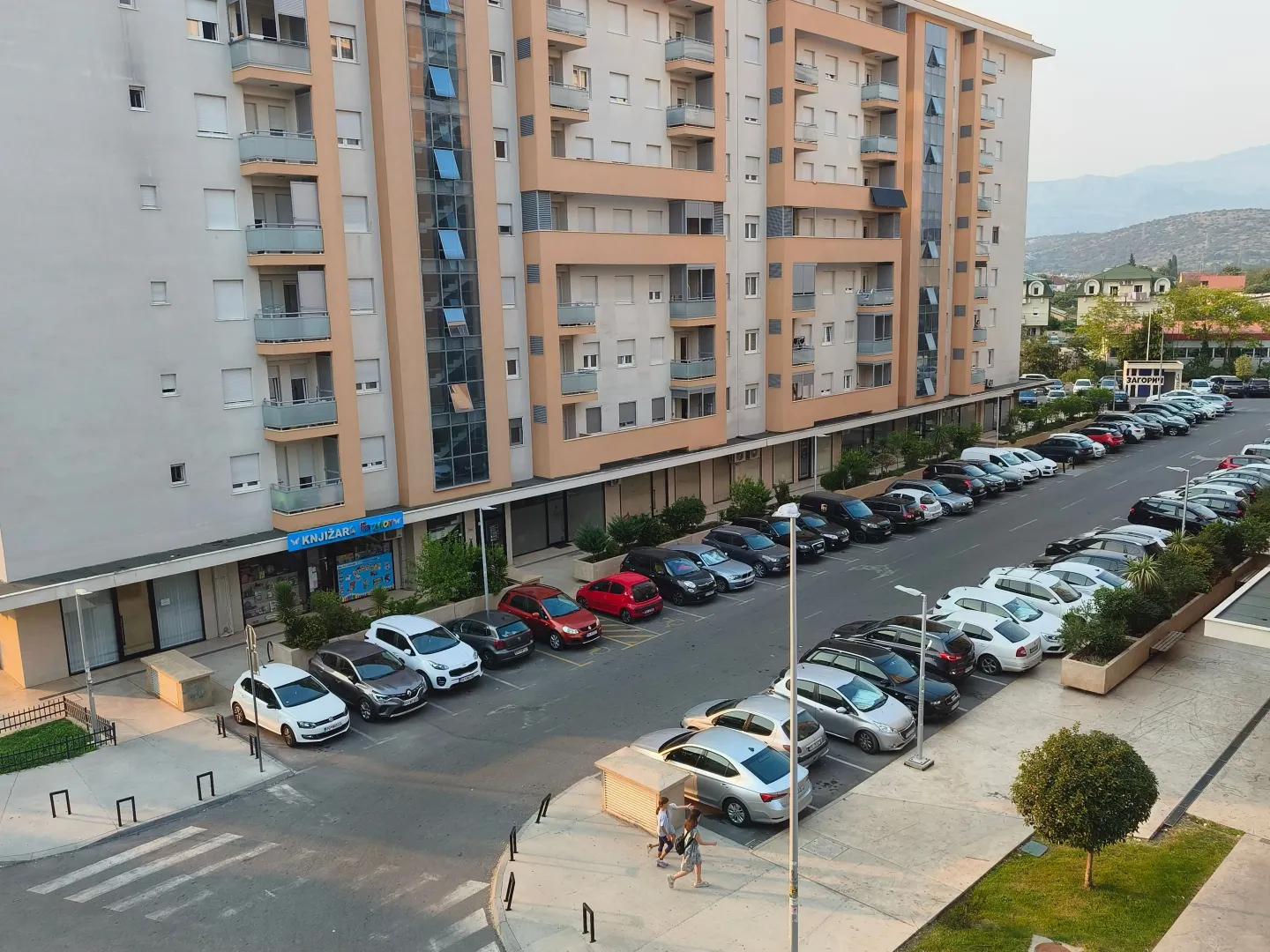 High-angle view of the apartment building and the parking lot in front of it.
