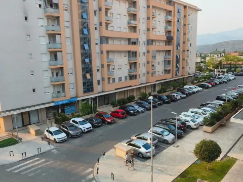 High-angle view of the apartment building and the parking lot in front of it. - image 5