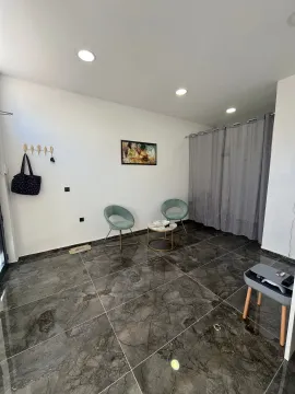 Living room with seating furniture and dark ceramic floor tiles. - image 2