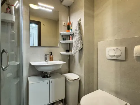 Savremeno opremljeno kupatilo sa tuš kabinom, umivaonikom i ugradnom sanitarijom. - image 5